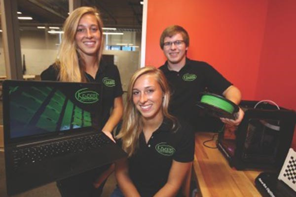 UMass Lowell seniors, twins Elizabeth Kender, center, and Laura, and their brother Stephen, a UML sophomore, are developing a flexible, modular body armor for sports protective equipment. Lowell Sun photo by Julie Malakie