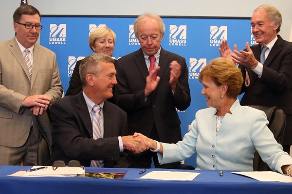 Lowell city manager Kevin Murphy and UMass Lowell chancellor Jacquie Moloney sign a master agreement with State Rep. Dave Nangle, State Sen. Eileen Donoghue, Lowell mayor Ed Kennedy and U.S. Sen. Ed Markey.