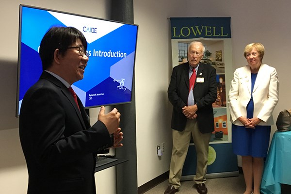 CAIDE Systems Founder and CEO Kyewook Jacob Lee speaks while  Mayor William Samaras and City Manager Eileen Donoghue, listen.