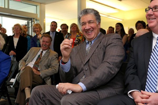 Steven Panagiotakos has a good laugh as he listens to the speakers during the UMass Lowell event Monday.