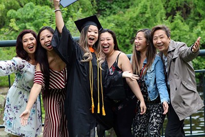 Happy Asian family celebrates UMass Lowell graduation