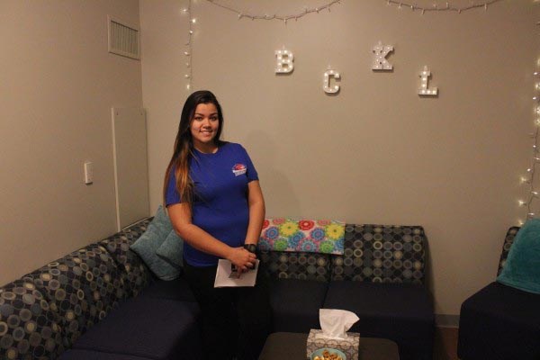 Student Shannon Arruda stands in a dorm room of the new second-floor of Riverview Suites East, where she is a resident adviser. Lowell Sun photo