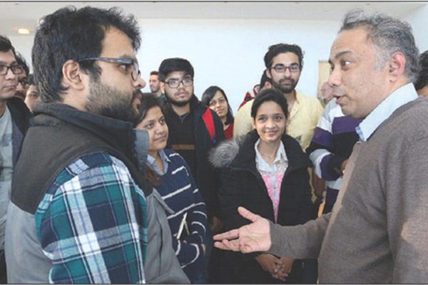 Renewable-energy entrepreneur Harish Hande speaks with students during his visit to UMass Lowell.