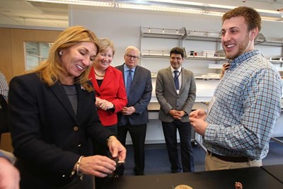 Lt. Gov. Karyn Polito looks at materials produced by a 3-D printer as Kyle Homan, a Ph.D. student in computer and electronics engineering, looks on at the Printed Electronics Research Collaborative at UMass Lowell on Tuesday. Watching, from left, are state Sen. Eileen Donoghue; Kenneth Hill, director of the Raytheon Mechanical Engineering Directorate; and Ph.D. student Mahdi Haghzadeh.