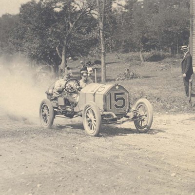 A driver racing down the Merrimack Valley Auto Course in 1908, which began and ended on Pawtucket Boulevard along the Merrimack River