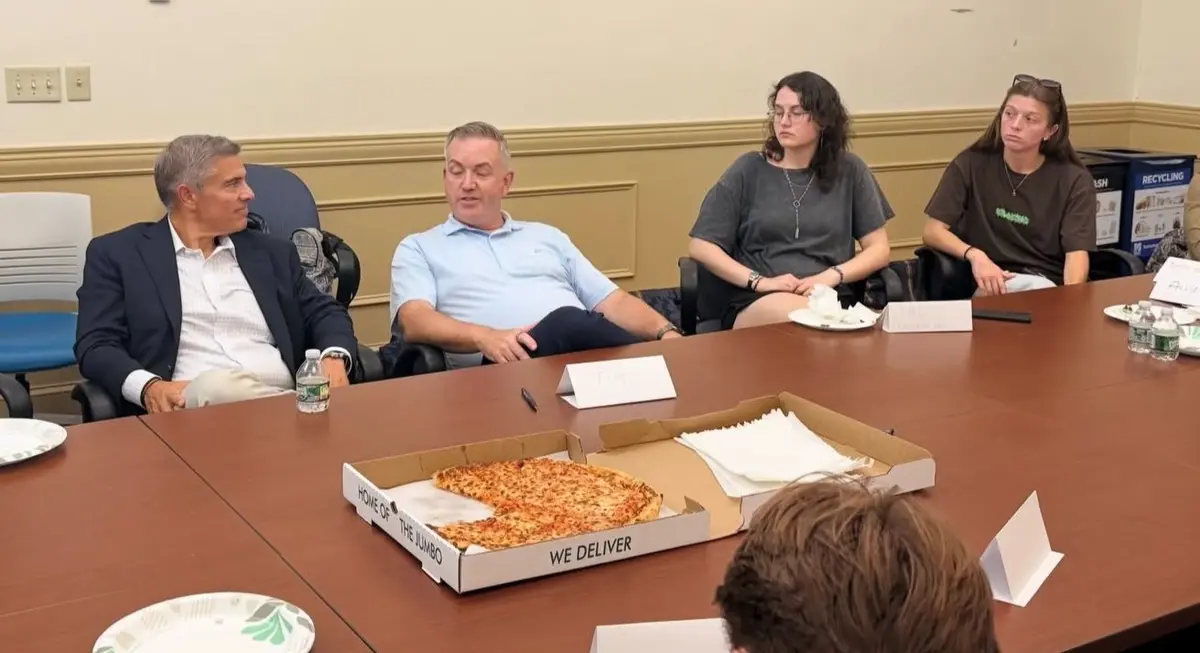 Tim Looney and Chris Meelia speak with Shah Academy students during a meet-and-greet session.
