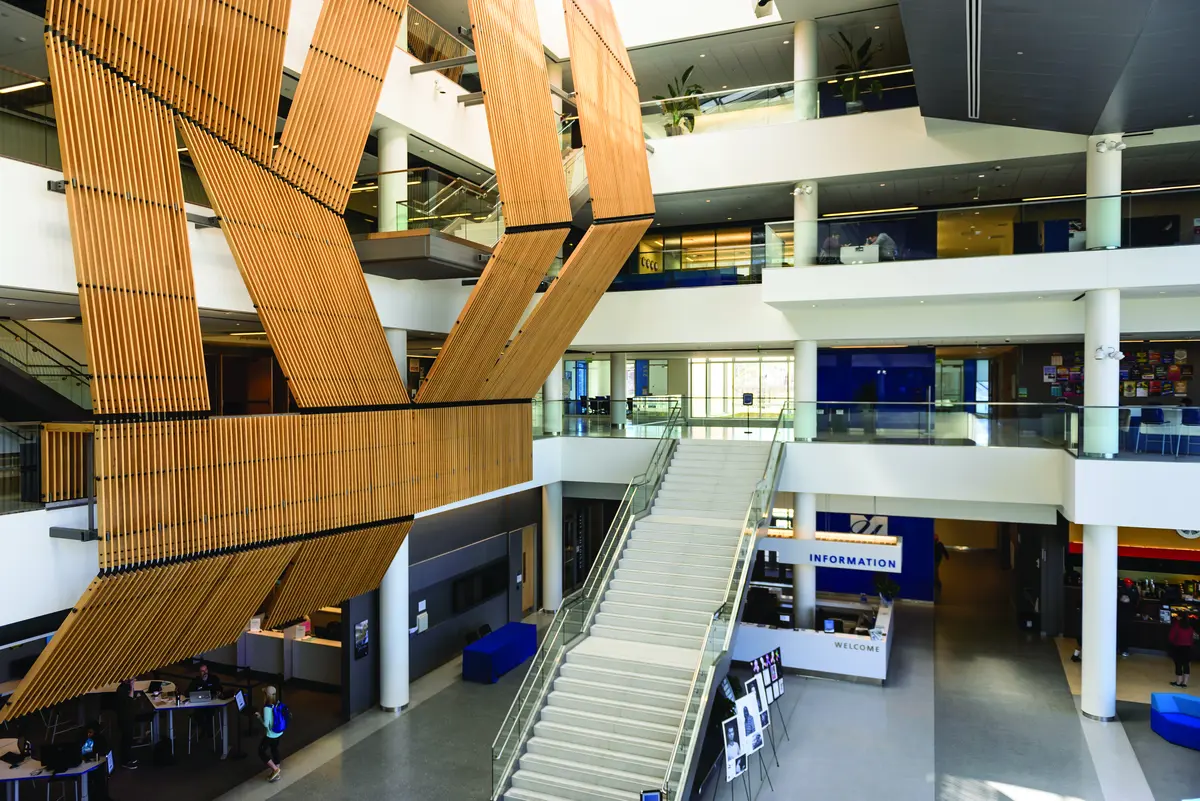 Massive wooden sculpture hanging in lobby of University Crossing