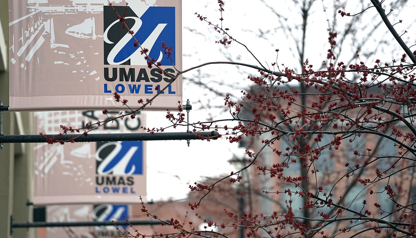 UMass Lowell banners hanging on side of building