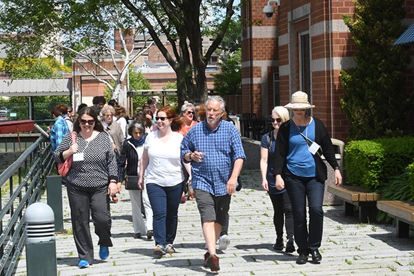 UML University Professor Robert Forrant leads a walking tour of Lowell at the opening of the Global Carework Summit