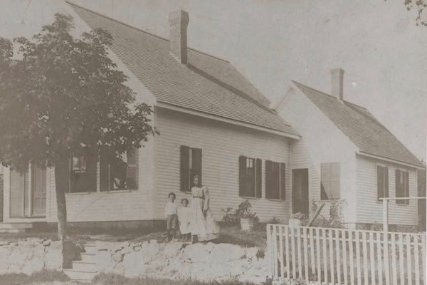 Family members standing in front of the Lew family home in Lowell