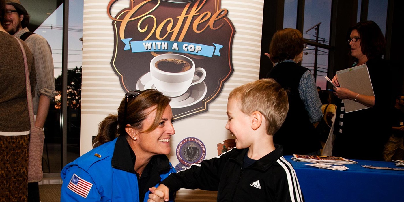 A little boy meets a female cop in an event, "Coffee with a cop".