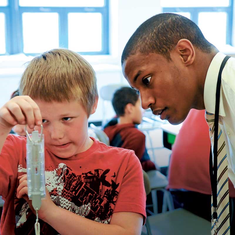 A male UMass Lowell UTeach student interacts with a student at the Sullivan School in Lowell, Mass. 