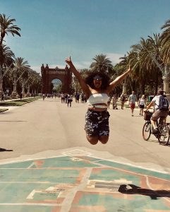 Study abroad student Cloris Lora jumping for joy in Barcelona