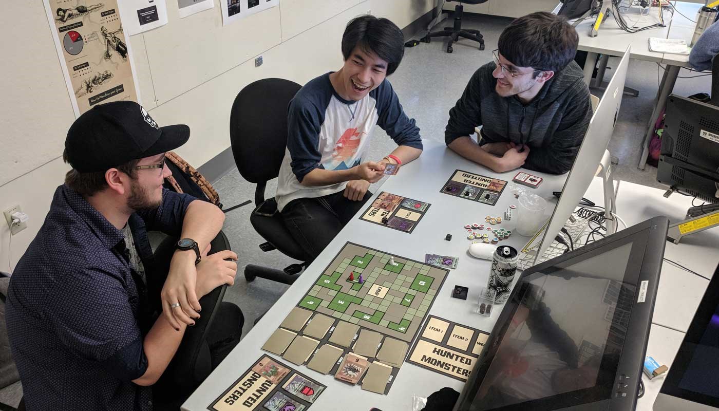 Students design a video game using cards and computers