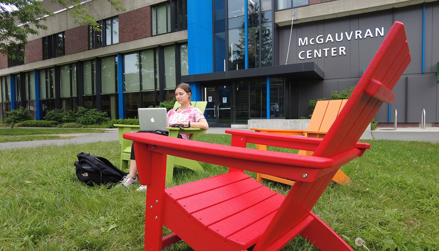 girl in front of mcgauvran on adirondack chair