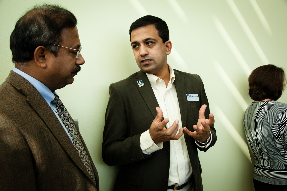  Vinod Vokkarane chats with a colleague at the opening of the Raytheon-UMass Lowell Research Institute.