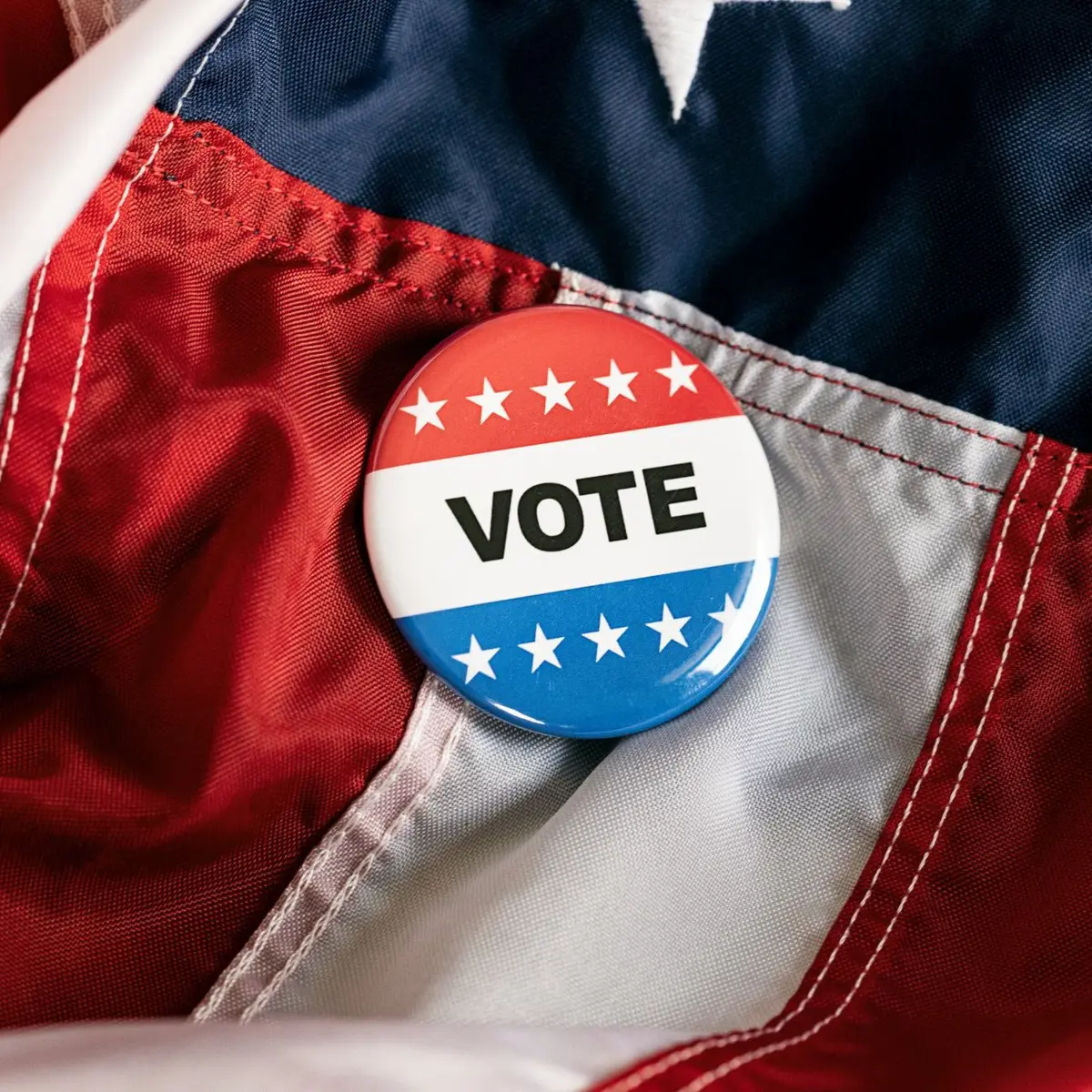 Vote button laying on a flag