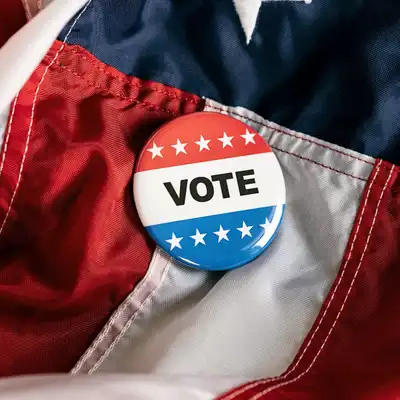 Vote button laying on a flag