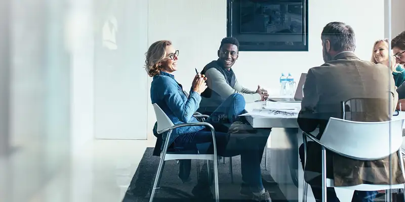 Five people sitting around a conference table