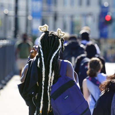 Back of young woman's head where her braids are formed into white hearts atop her head