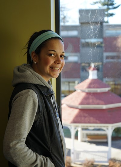 Headshot of Zayna Basma in a building on South Campus looking down on the gazebo