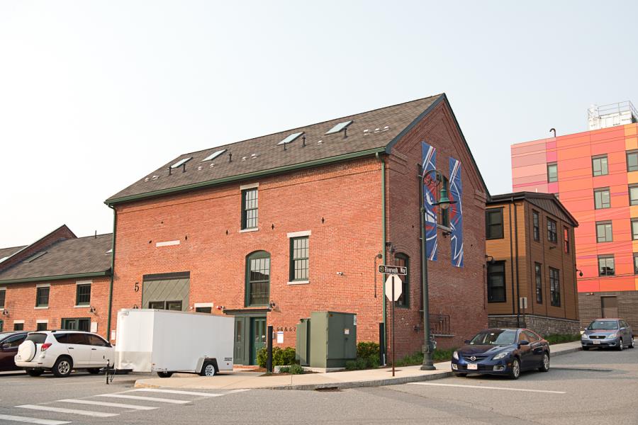Street parking alongside back of brick complex
