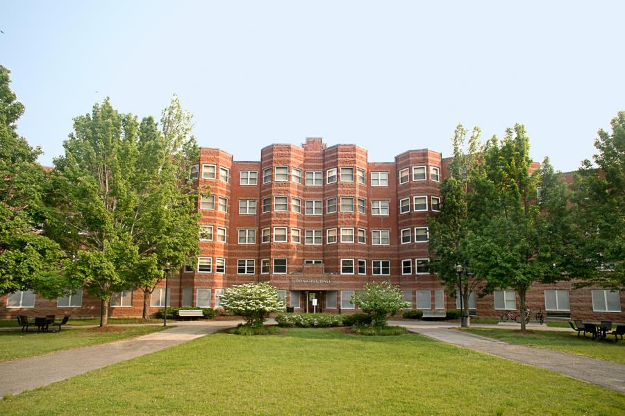 Front of Donahue Hall showing grass and trees