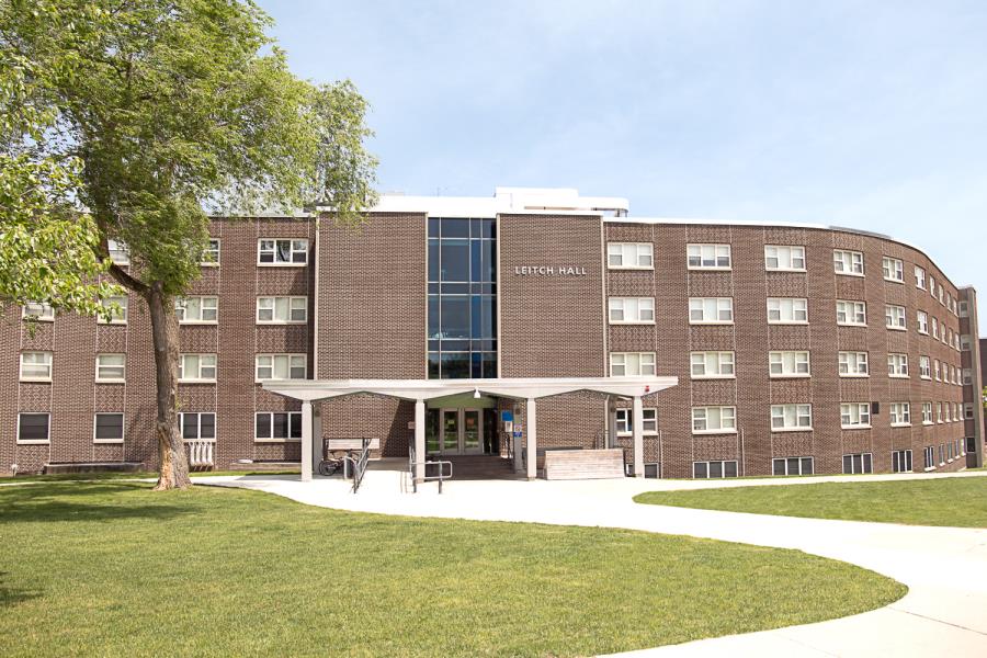 Front entrance of Leitch Hall showing grass and curved walkway