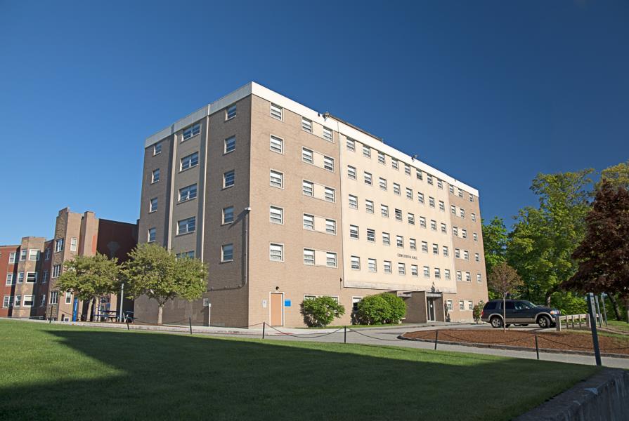 Flat-roofed five-story brick rectangular dormitory