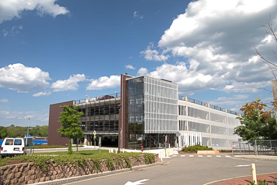 Four-story parking garage with enclosed staircase on outside
