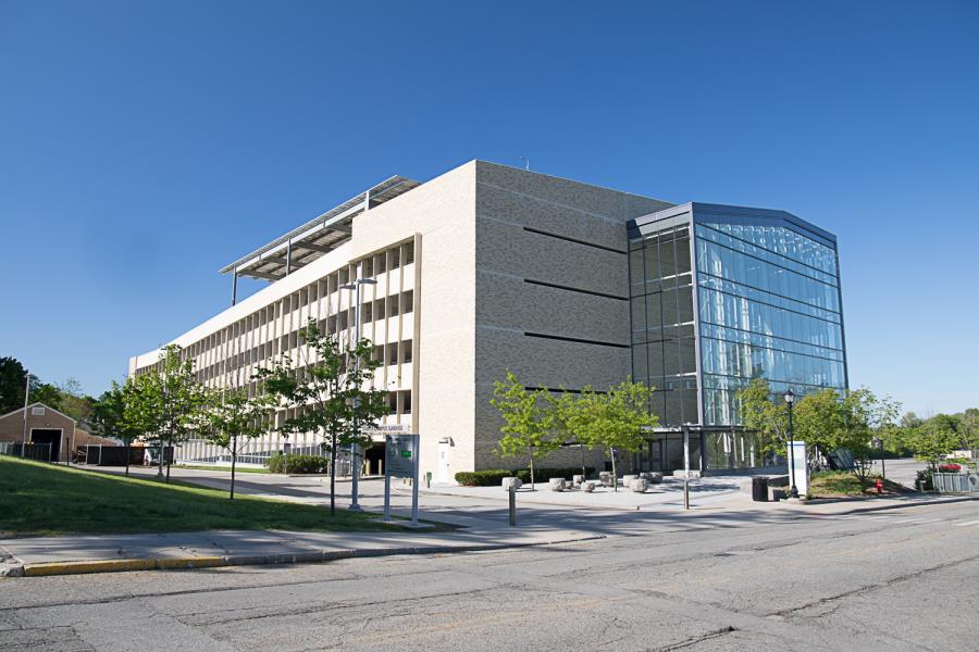 Six-story parking garage with glass-enclosed stairwell on side