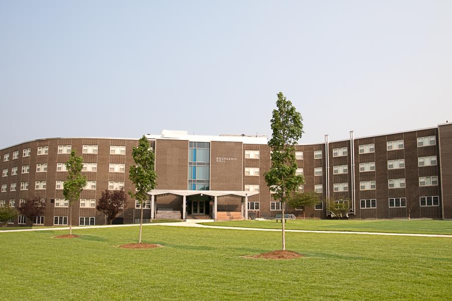 Front entrance of Bourgeois Hall showing grass and trees