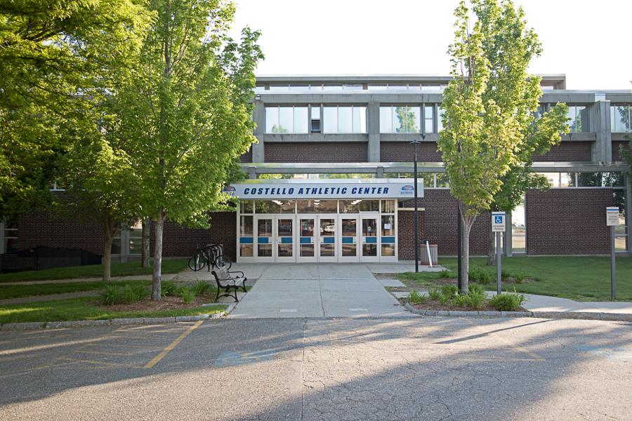 Front entrance of athletic center with bench and bike rack