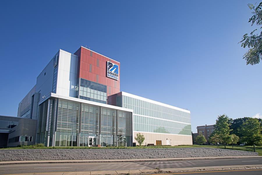 Modern, glass-fronted building with louvered panels on front