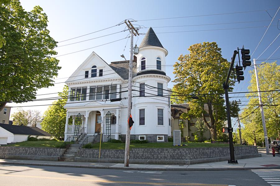Turn of century three-story white home with turret on right side