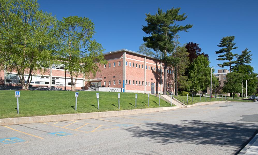 Designated parking spaces alongside front of red brick building