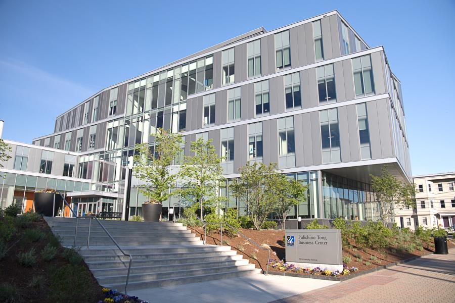 Multilevel staircase leading to modern, four-story gray building 