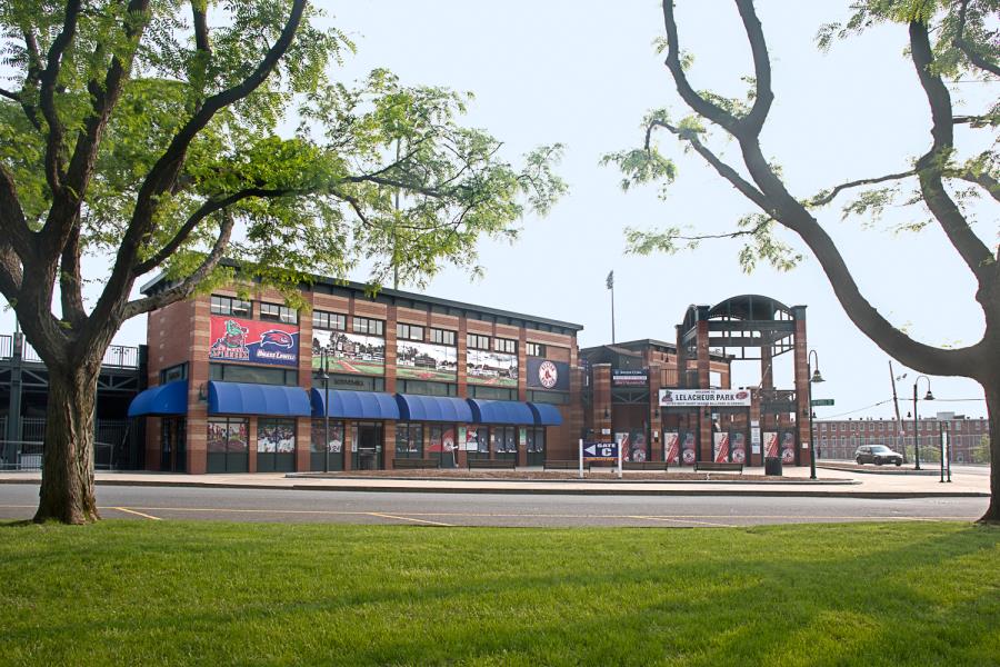 Ballpark entrance showing blue awnings and banners on building