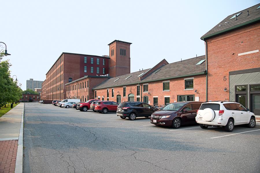 Street parking alongside back of brick complex