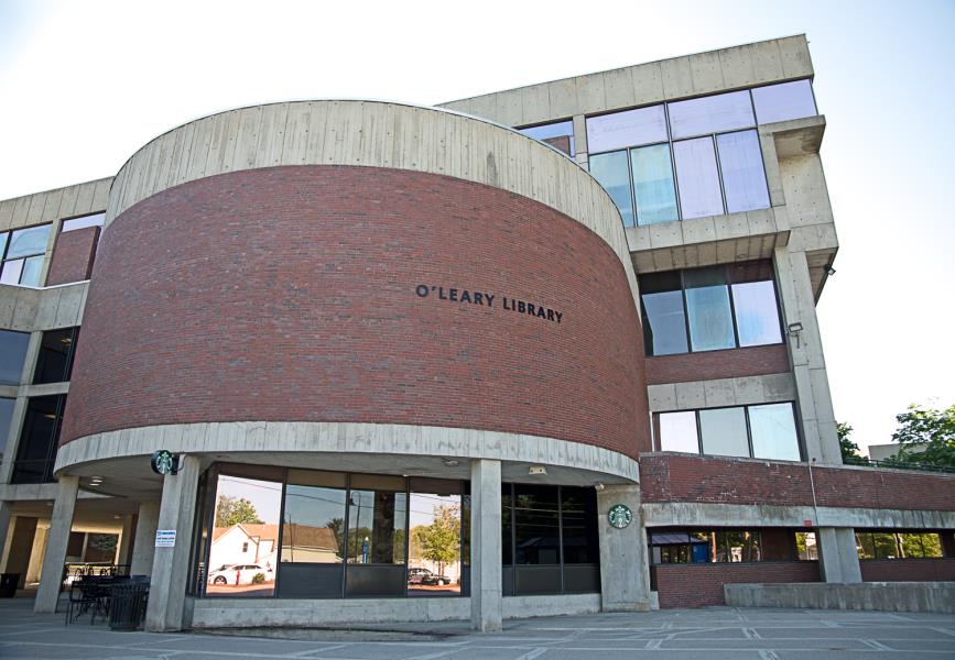 Rounded three-story entrance to red brick O’Leary Library