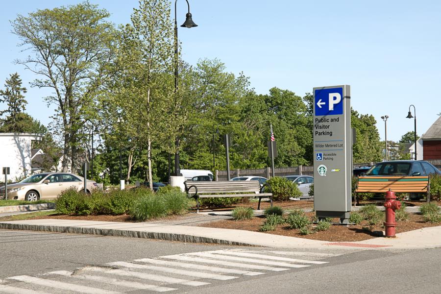 Sign designating entrance to public and visitor parking at Wilder Metered Lot