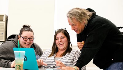 Two female students with Drew Hayden Taylor, author and playwright, during master class